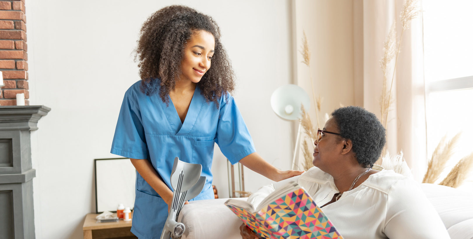 Talking to nurse. Dark-eyed woman with short hair cut wearing glasses reading the book and talking to nurse